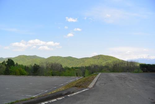 an empty parking lot with mountains in the background at Highland Furano in Furano