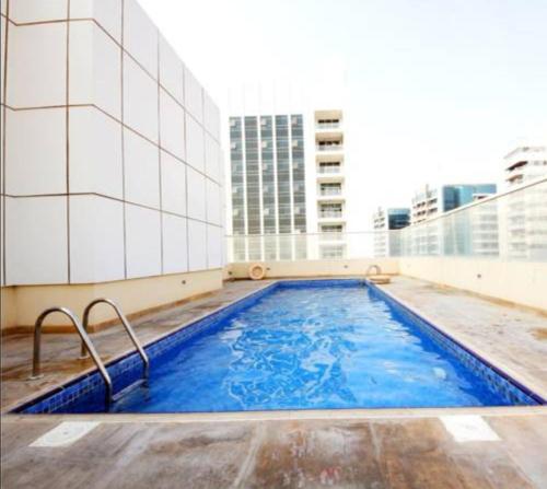 a large swimming pool on top of a building at Amazing Homestay Partition Room for 1 in Dubai