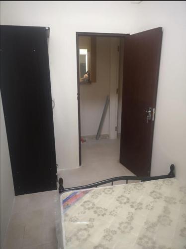 a room with two doors and a bed in it at Amazing Homestay Partition Room for 1 in Dubai