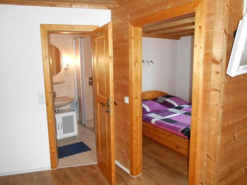 a small bedroom with a bed and a bathroom at Ferienwohnung Mayer in Waging am See