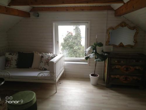 a living room with a couch and a window at Holiday Home Wanderlust Lendava in Lendava