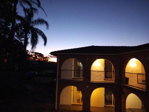 a building at night with the lights on at Bay House Motel in Bateau Bay