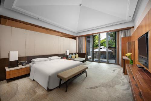 a bedroom with a large bed and a television at InterContinental Kunming by IHG in Kunming