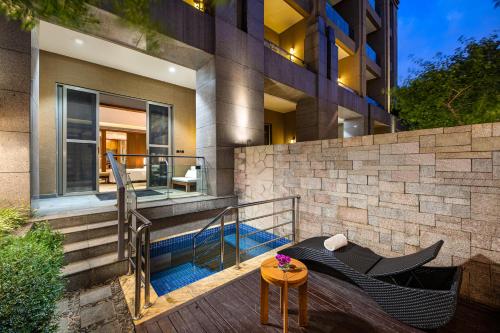 a house with a balcony with a table and chairs at InterContinental Kunming by IHG in Kunming