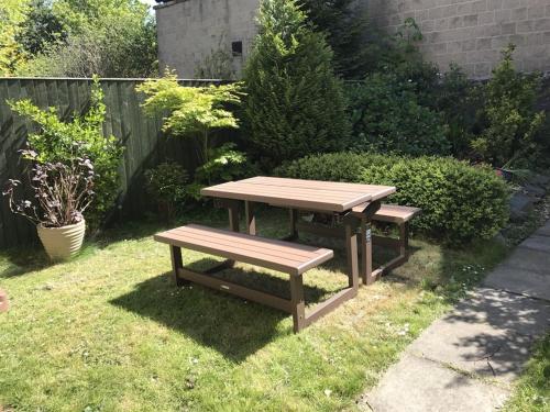 a picnic table and a bench in a yard at Alba House in Edinburgh