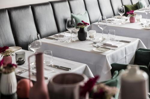 a group of tables with wine glasses on them at NIDUM - Casual Luxury Hotel in Seefeld in Tirol