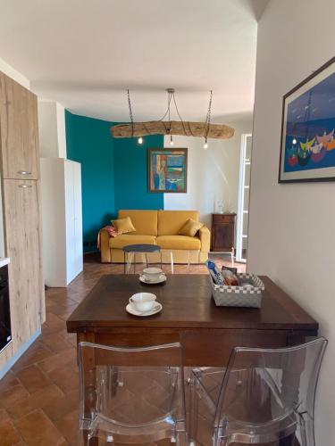 a living room with a table and a couch at Ca di Matti - Casa Ferla in Diano Borello