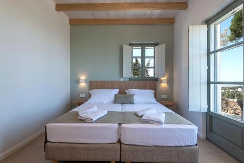Кровать или кровати в номере AnamneZia Luxury Suites