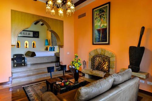 a living room with a couch and a fireplace at Lazib Inn Resort & Spa in Tunis