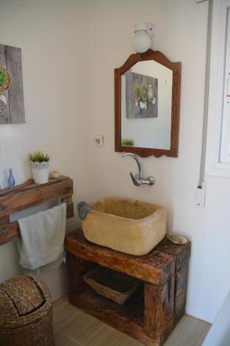 uma casa de banho com um lavatório de pedra e um espelho. em CHALET CON PISCINA A 1 KILOMETRO DE LA PLAYA CARTAGENA em Cartagena
