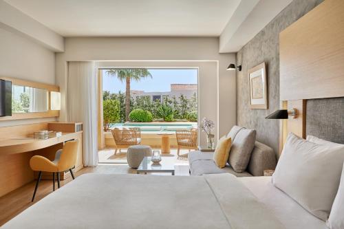 プラタニアスにあるMinoa Palace Resortのベッドルーム1室(ベッド1台付)、リビングルームが備わります。