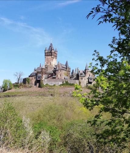 an old castle sitting on top of a hill at Moselromantik Hotel Am Panoramabogen in Cochem