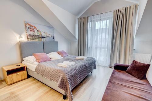 Postel nebo postele na pokoji v ubytování Apartamenty Zdrojowa