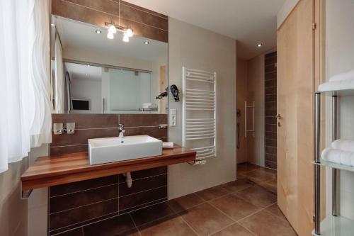 a bathroom with a sink and a mirror at Ferienwohnungen Renberg in Maria Alm am Steinernen Meer