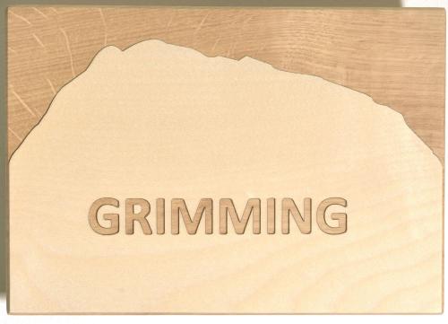 a piece of wood with the word grimm written on it at Appartements Kolb in Tauplitz