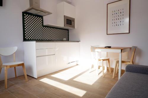 a small kitchen with a table and chairs in a room at Hotel Andalucia in Lanjarón