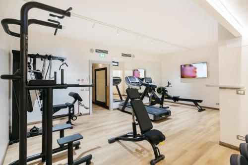 a gym with treadmills and ellipticals in a room at FH55 Grand Hotel Palatino in Rome