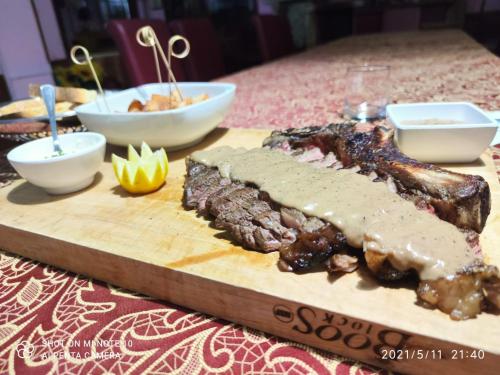 a steak on a cutting board on a table at Hotel Elimo in Erice