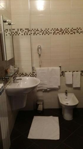 a bathroom with a sink and a toilet at HOTEL SIRIO in Villa D'agri