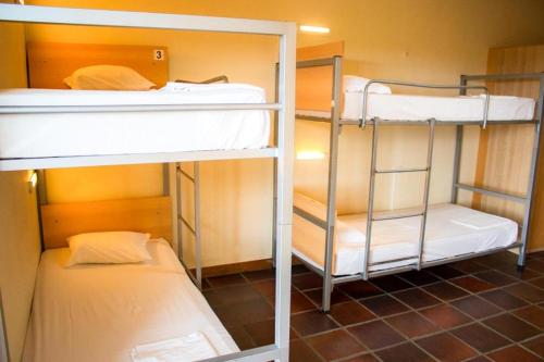 two bunk beds in a small room with at HI Almada - Pousada de Juventude in Almada