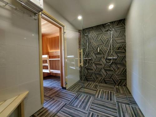 a bathroom with a shower and a walk in shower at Fishing and holiday village Merikoivula in Uusikaupunki