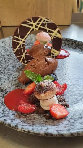 a dessert with chocolate and strawberries on a plate at Gasthof Pension Santeler in Sankt Leonhard im Pitztal