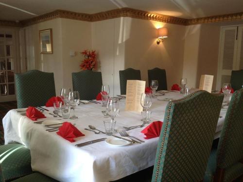 a dining table with red napkins and wine glasses at Tweeddale Arms Hotel in Gifford