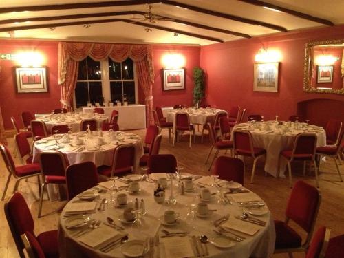 a room full of tables and chairs with white tablecloths at Tweeddale Arms Hotel in Gifford