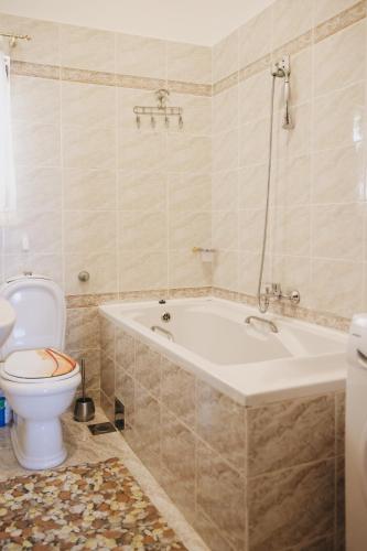 a bathroom with a tub and a toilet and a sink at Apartment Blanka with a beautiful view of Trogir in Trogir