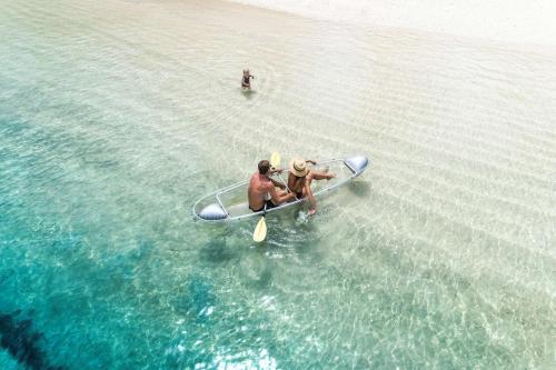 a group of people in a boat in the water at Shangri-La Yanuca Island, Fiji in Voua