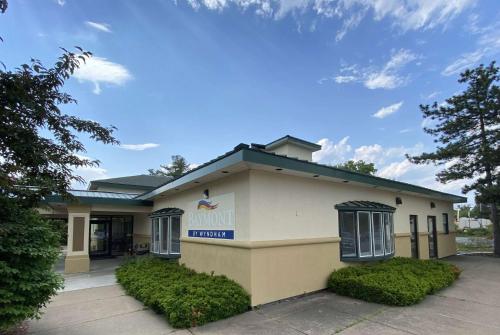 a building with a sign on the side of it at Baymont by Wyndham Latham Albany Airport in Latham
