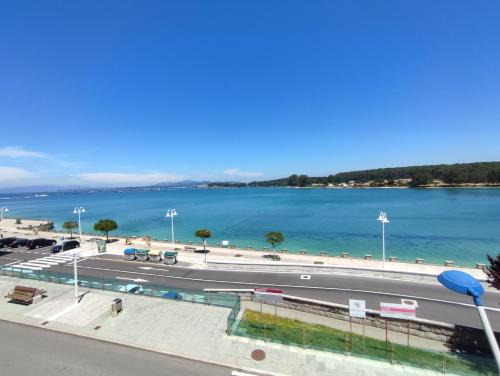 a view of a road and a body of water at Hotel Brisa del Mar in O Grove