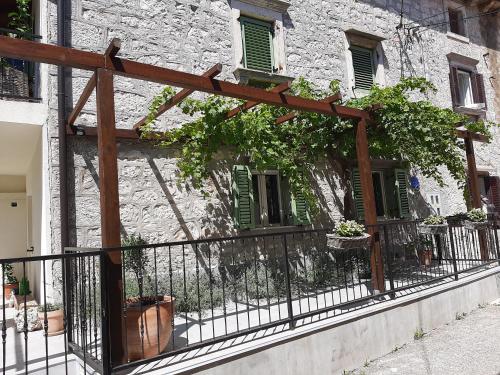 a stone building with a fence and plants on it at Casa Nonna Tereza in Premantura