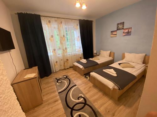 En eller flere senge i et værelse på Guest House Zoreni