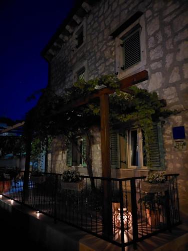 a building with a sign on the side of it at night at Casa Nonna Tereza in Premantura
