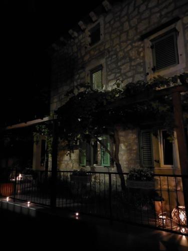 a building with a fence in front of it at night at Casa Nonna Tereza in Premantura