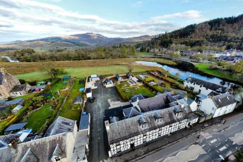 an aerial view of a village with a river and buildings at Callander Hostel in Callander