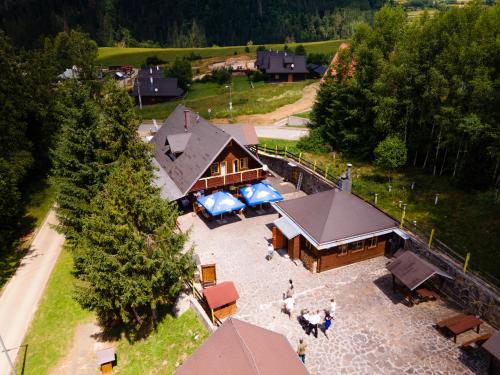 an aerial view of a house with people standing in front of it at SKI CIERNY BALOG in Čierny Blh