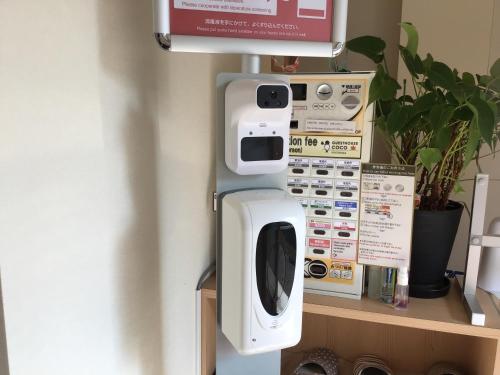 a machine on top of a shelf in a room at Guesthouse COCO Hiroshima (Female Only) in Hiroshima