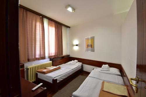a hospital room with two beds and a window at Apartments JAT Kopaonik in Kopaonik