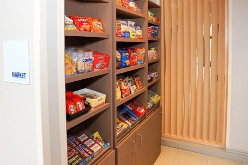 a walk in pantry filled with lots of food at Holiday Inn Express & Suites - Aurora Medical Campus by IHG in Aurora