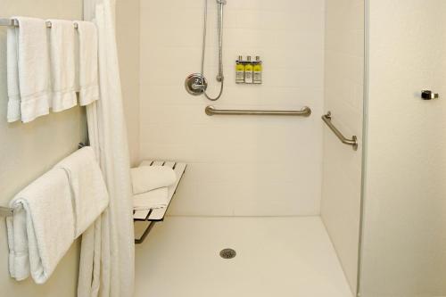 a white bathroom with a shower and a toilet at Holiday Inn Express & Suites - Aurora Medical Campus by IHG in Aurora