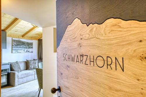 a door in a living room with a sign that readssavushima at Chalet Schlossberg Schwarzhorn in Nova Ponente