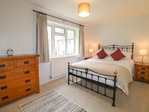 a bedroom with a bed and a dresser and a window at Tuliptree in Chesterfield