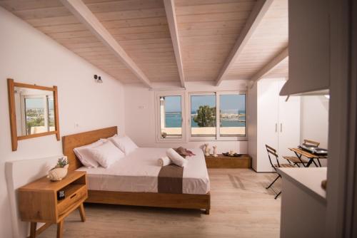 a bedroom with a large bed and windows at Nonna Irene in Rethymno