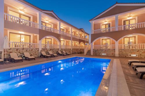 a hotel with a swimming pool in front of a building at Zante Holidays Hotel in Kalamaki