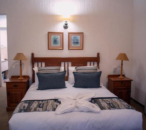a bedroom with a bed with a bow on it at Kruger Park Lodge Unit 245 in Hazyview