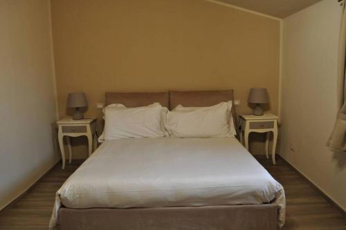 En eller flere senge i et værelse på appartamento Le Mongolfiere