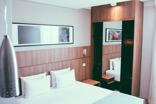 Postel nebo postele na pokoji v ubytování Occitano Apart Hotel