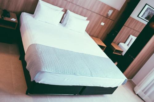 Postel nebo postele na pokoji v ubytování Occitano Apart Hotel